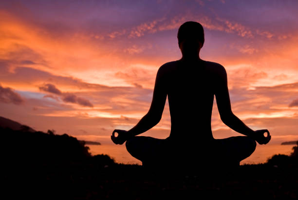 istock Woman meditating in sunset. 168508095