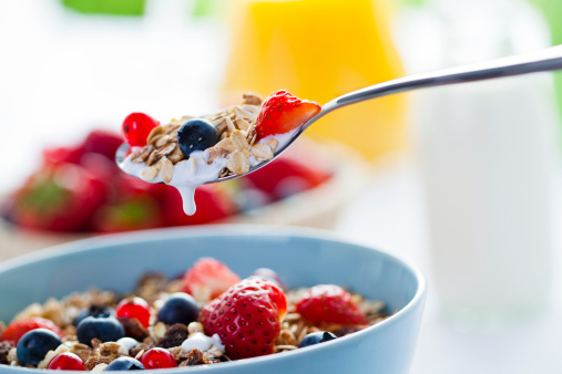Cereals with fresh fruits on a spoon