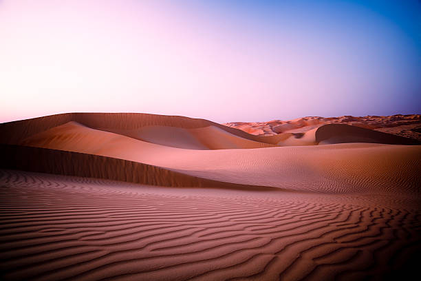 Desert Twilight Rub' al Khali of Abu Dhabi, UAE Large sand dunes in the desert reaching till the horizon at mystic twilight at night time, right after sunset / dusk. landscape fog africa beauty in nature stock pictures, royalty-free photos & images