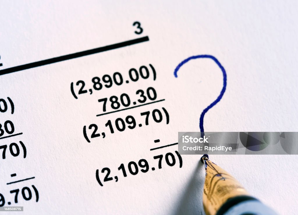 Fountain pen puts question mark by column of numbers. Problems? A fountain pen puts a question mark next to a column of figures. Something wrong somewhere! Confusion Stock Photo