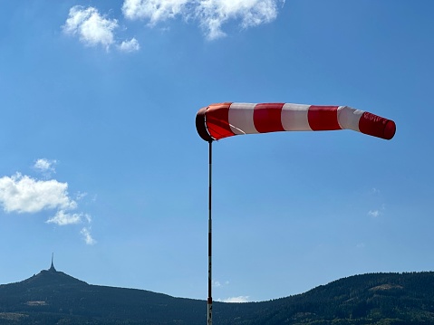 windy weather at a small airport under the mountains, wind mark