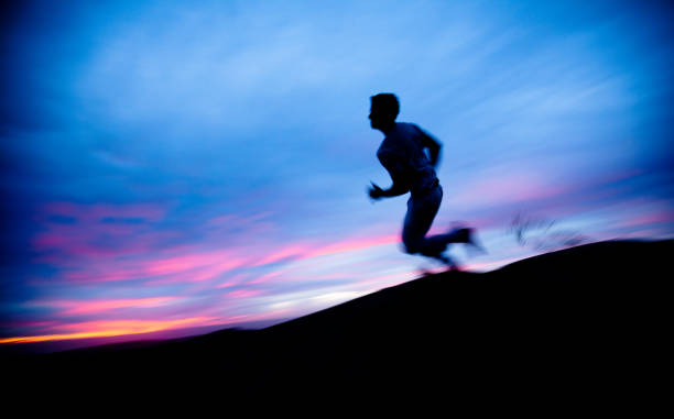 istock Solitary figure running through the desert at sunset 168510534