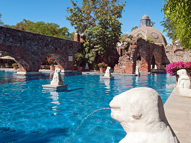Hotel Swimming Pool The ruins of old buildings have been transformed into a luxurious swimming pool at an old hacienda in Cuernavaca, Mexico. cuernavaca stock pictures, royalty-free photos & images