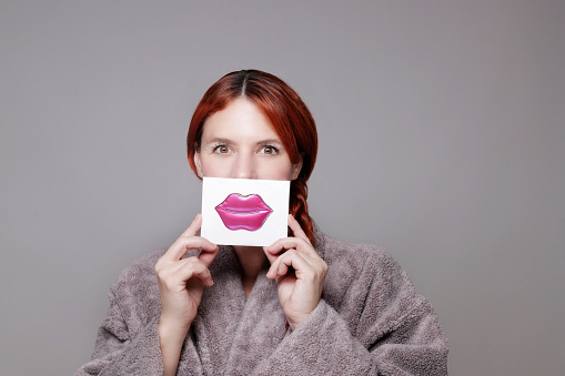 woman showing lip moisturizing patch
