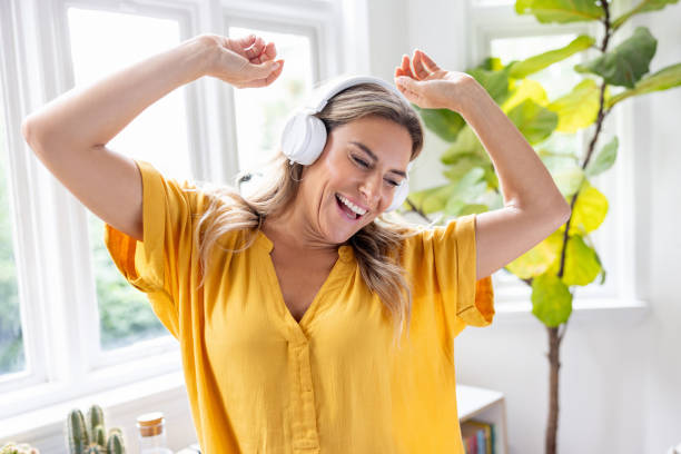 istock Happy woman dancing at home 1685138647