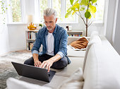 Man working at home on his laptop computer
