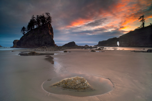 A stunning sunset over the famous sea stacks and arch at Second Beach on the Olympic National Park, near Seattle, Washington State, USA.