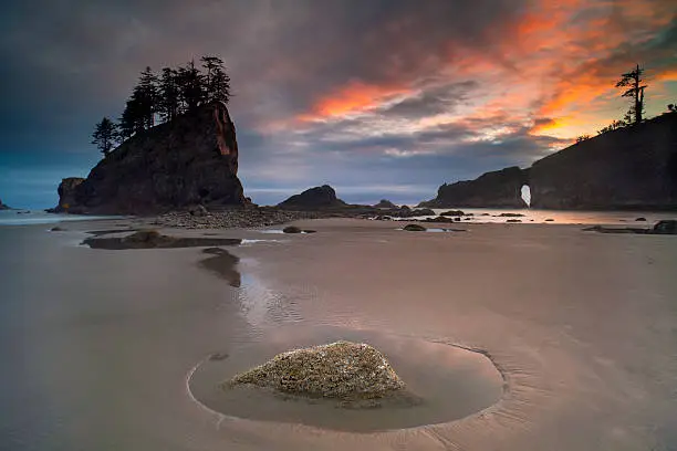 A stunning sunset over the famous sea stacks and arch at Second Beach on the Olympic National Park, near Seattle, Washington State, USA.