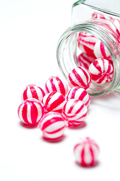 istock Pink and white sweets spilling out of a jar 168517956