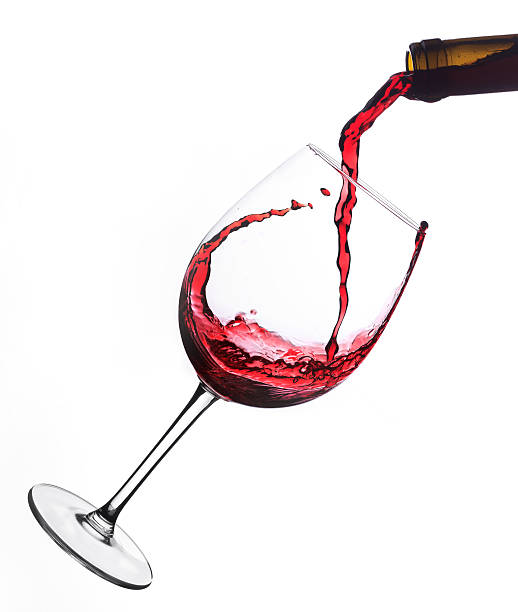 Red wine  poured into glas Red wine  poured into glas pouring stock pictures, royalty-free photos & images