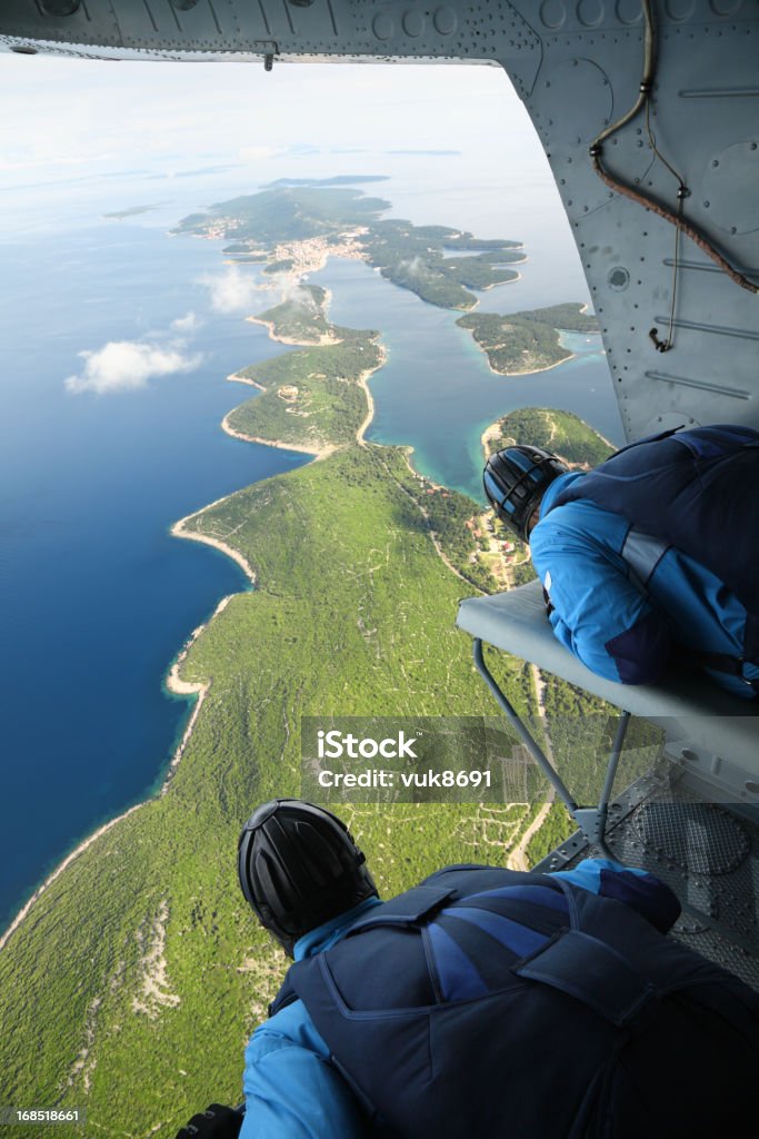 Prepares to jump Two are preparing for a parachutist jump from a helicopter in the area over the island of Losinj-Croatia Airplane Stock Photo