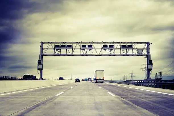 Truck toll system, german highway - control gantry, some minor motion blurring. Cross-processed image