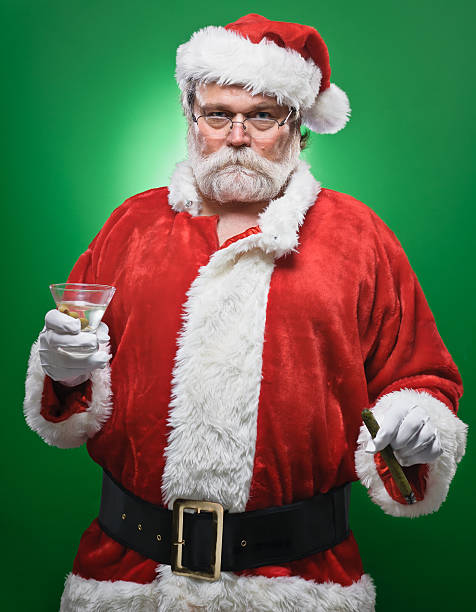 Naught Santa drinking a cocktail stock photo