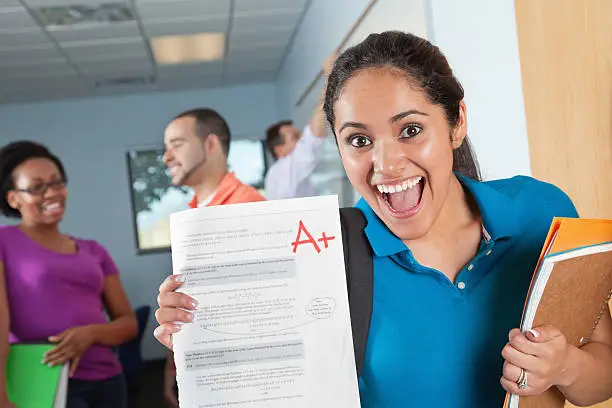 Photo of Happy Female Student in Class With Great Test Grade