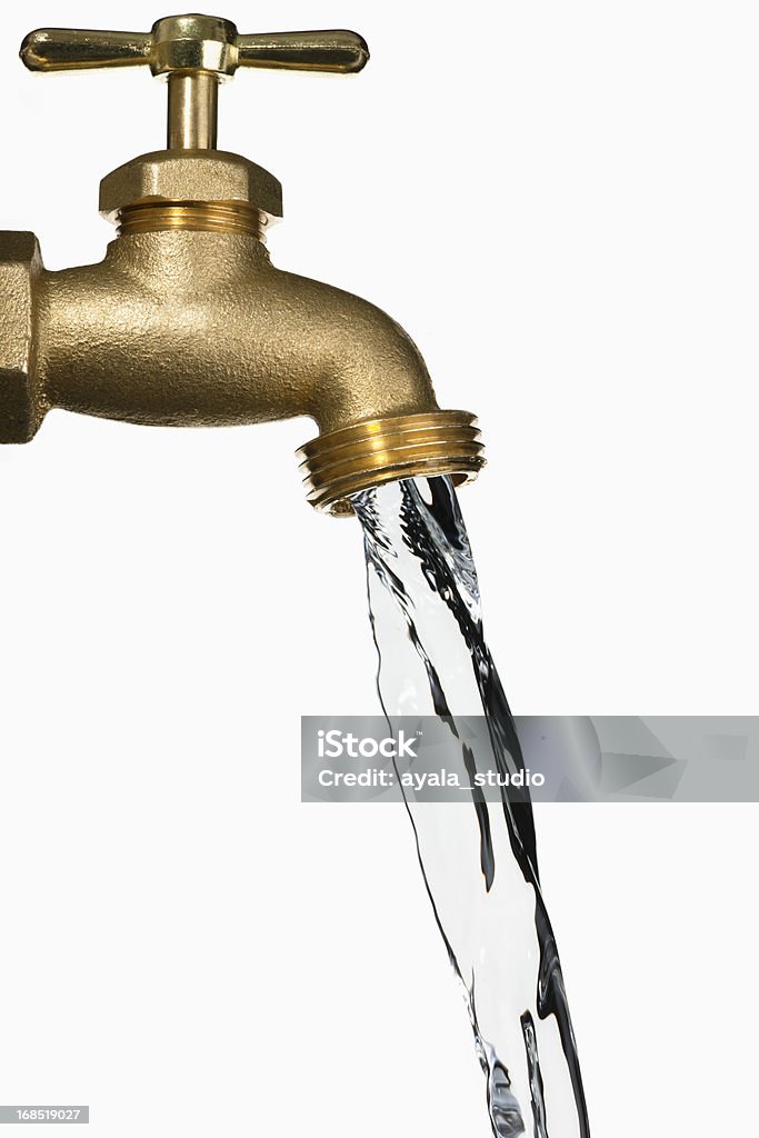 A bronze water faucet running isolated on white Water being poured from water faucet, close up with white background. Water Stock Photo