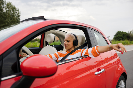 Woman driving car and listening music