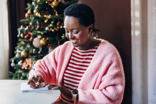 istock Woman Writing Her New Year's Resolutions 1685207499