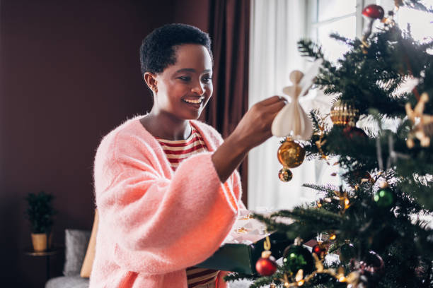 istock Woman Decorating Christmas Tree 1685207507