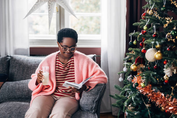 istock Woman Reading a Book on a Christmas Day 1685209094