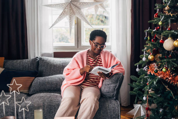 istock Woman Reading a Book on a Christmas Day 1685209095
