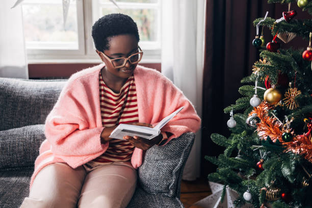 istock Woman Reading a Book on a Christmas Day 1685209106