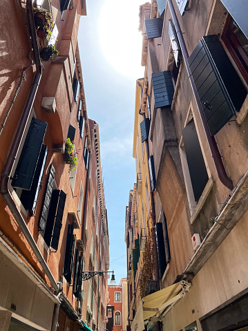 Stock photo showing close-up view of building exteriors lining Riva degli Schiavoni Venetian waterfront narrow streets, Venice, Italy.