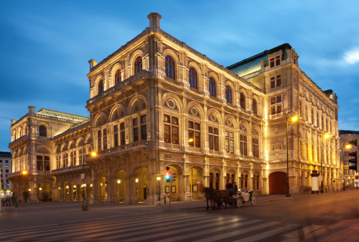 The Opera House in Vienna in the evening right after sunset with the typical Vienna Fiaker (Horse coach) in front. Nikon D3X. Converted from RAW.