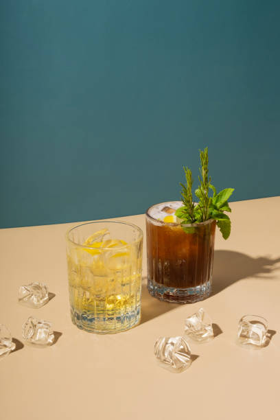istock Alcoholic cocktails and ice on colored backgrounds with hard shadows. 1685268671