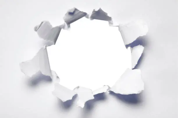 A hole punched into white paper.