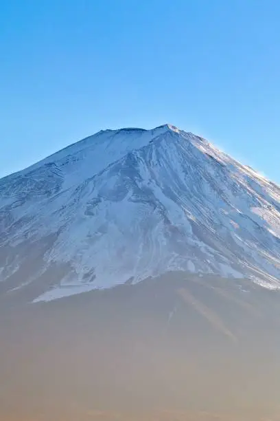 Photo of Majestic Mount Fiji peak blanketed in a layer of fresh white snow