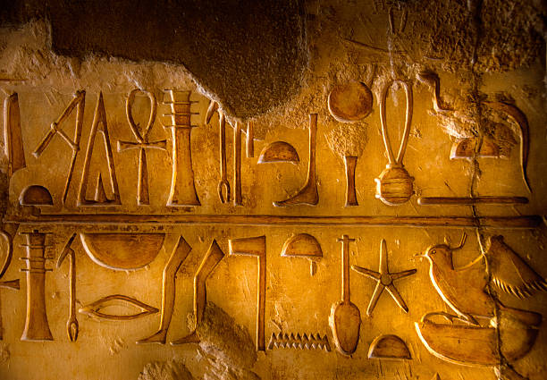 Two rows of Egyptian Hieroglyphics Hieroglyphs within a tomb in the Valley of the Kings. hieroglyphics photos stock pictures, royalty-free photos & images