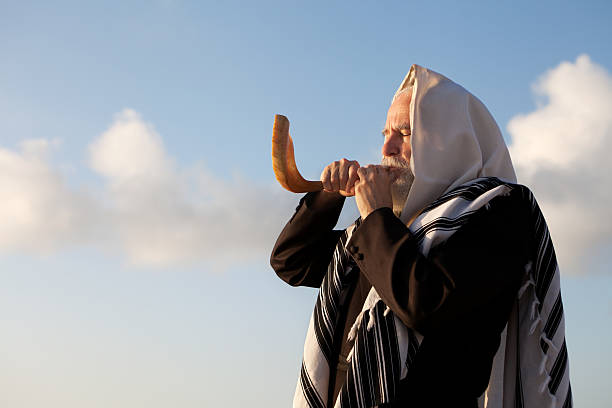 Elder Jewish man blowing a Shofar on Rosh Hashanah Rabbi blowing the shofar for the Jewish New Year hasidism photos stock pictures, royalty-free photos & images