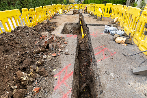 A hole of grease trap underground tank with the drain system around the house.