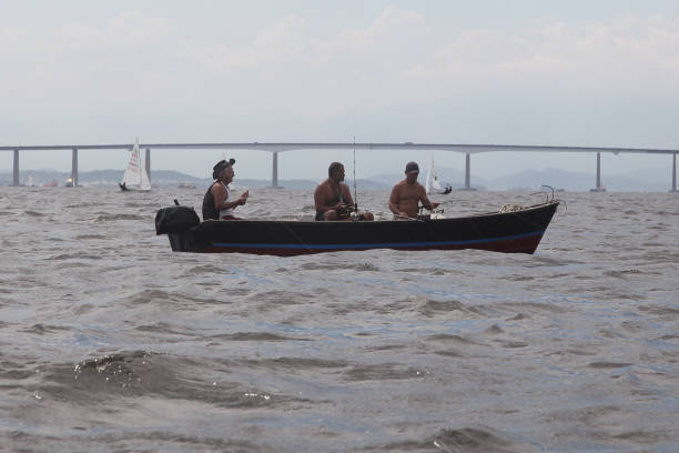 three Rio fishermen in a small boat stock photo
