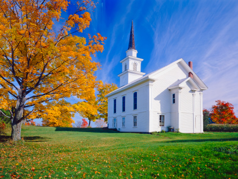 Autumn sugar maple and country church in Vermont