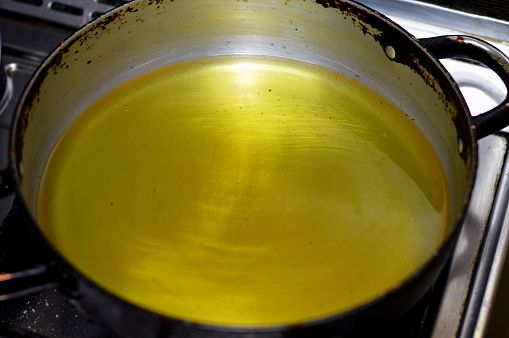 food oil in a pan ready for frying fast food, mixture of sunflower, corn, soybean and natural oil that has multi uses in kitchen in cooking various food and in frying many cuisines, selective focus