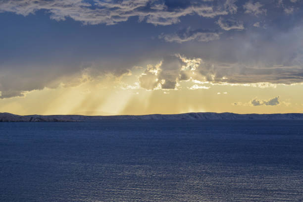 istock Storm clouds over Pag island with sun beams breaking through clouds in background 1685363770