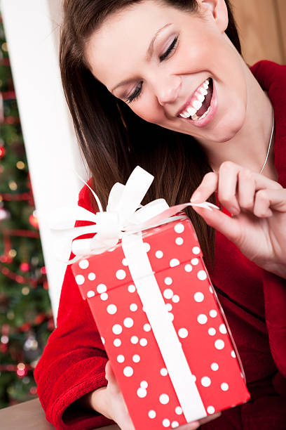 istock Smiling woman opening christmas present 168536944