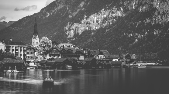 Amazing scenery of austrian town Hallstatt at the lake and high mountains, black and white photo