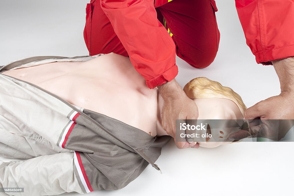 First aid - CPR practice First aid - CPR practice, pull up the chin. Move the head sidewards, open the mouth and clear the airway. Absence Stock Photo