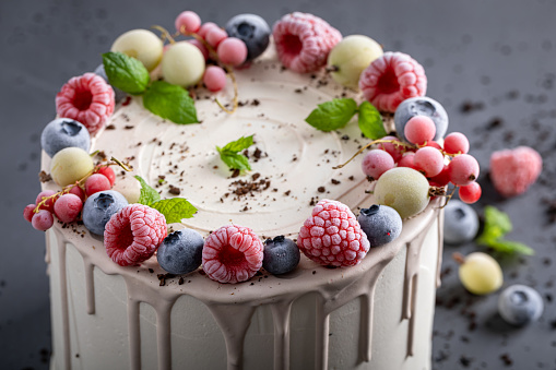 Sweet and tasty cake with raspberries and blueberries. Berries cake with white chocolate.