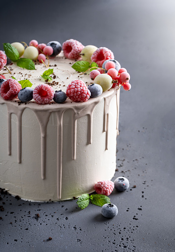 Sweet and tasty cake with coffee beans and berry fruits Berries cake with white chocolate.