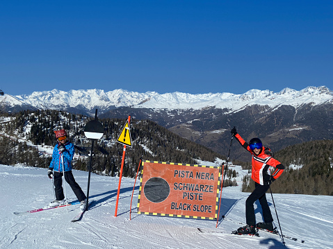 Mother and daughter about to ski down the Black steep slope