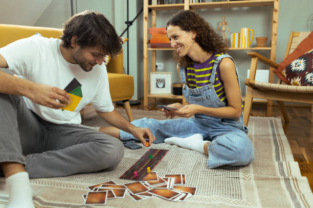 istock Young couple playing a board game at home 1685505789
