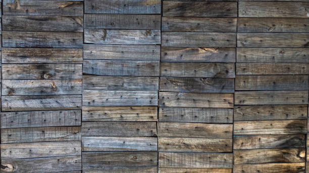 Front view of wall made with provisional wooden boards in a construction site of a building
