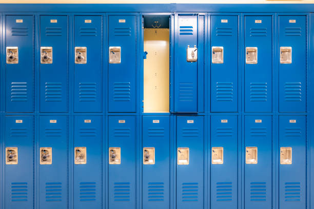 istock Single open empty blue metal locker along a nondescript hallway in a typical US High School. No identifiable information included and nobody in the hall. 1685521692