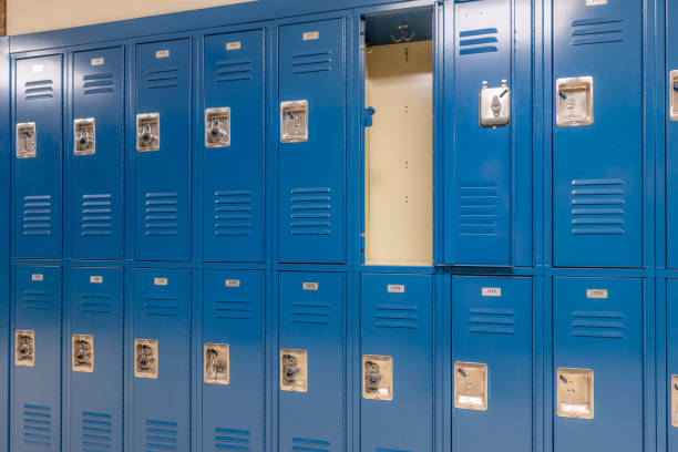 istock Single open empty blue metal locker along a nondescript hallway in a typical US High School. No identifiable information included and nobody in the hall. 1685521694