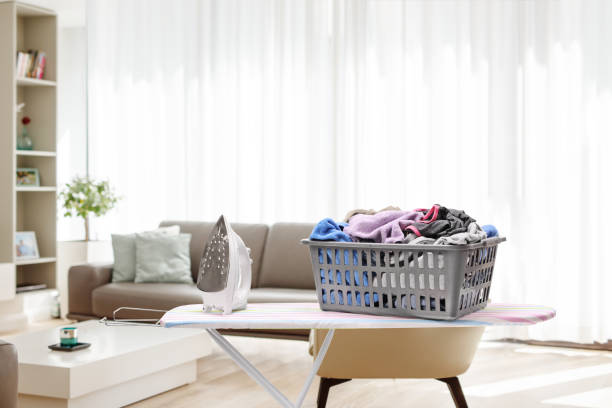istock Ironing board with a laundry basket full of clothes 1685530606