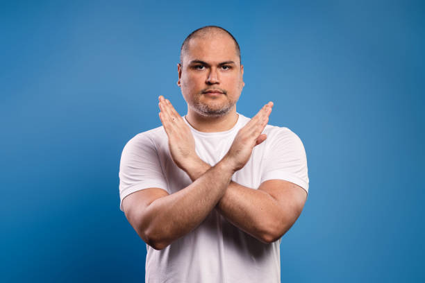 istock Man with arms crossed making an x 1685531005