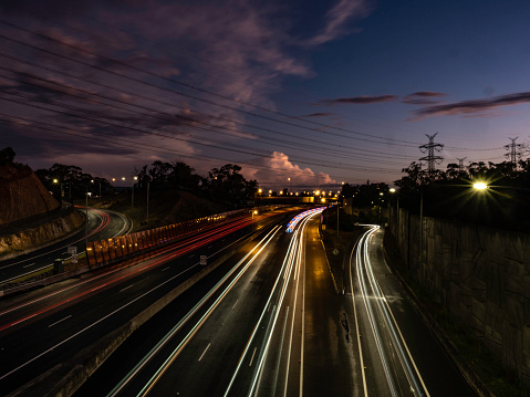 Melbourne multi lane free way with light trails and urban skyline